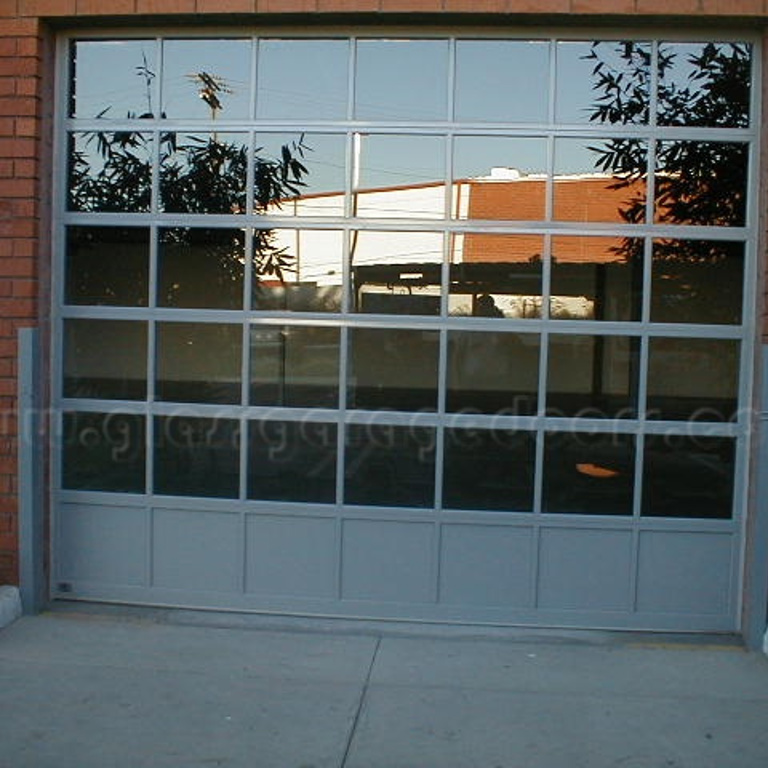 Transparent glass garage doors in Santa Monica, CA, enhancing the curb appeal of commercial building