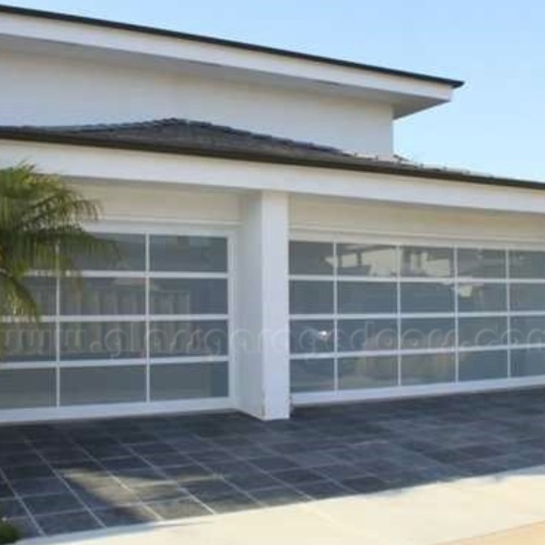 Contemporary design with two glass garage doors at upscale Newport Beach residence