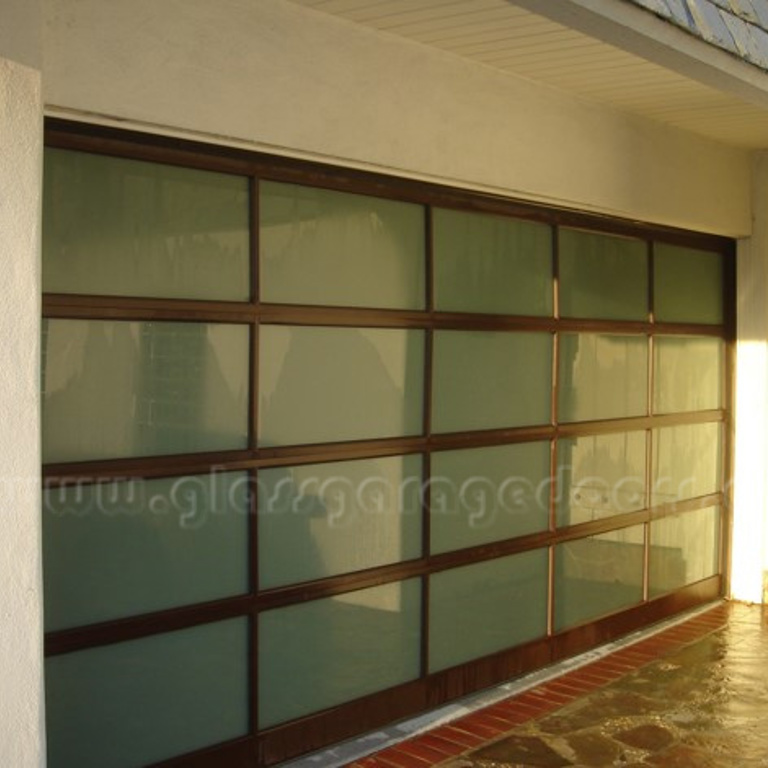 Contemporary brown glass garage door enhancing the exterior of a Newport Beach California home