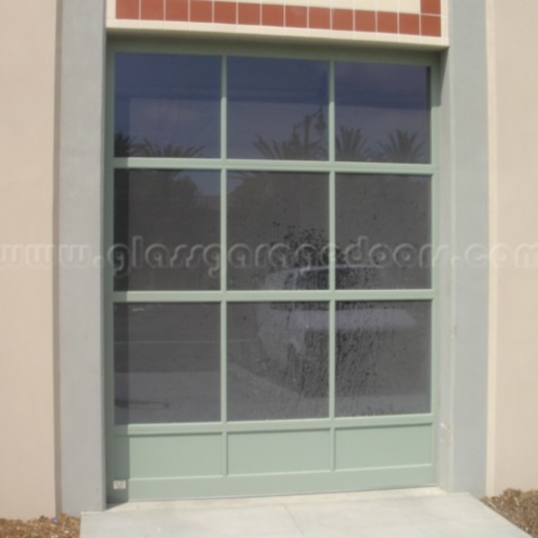 High-end glass garage door in San Diego, CA, enhancing side of a building with minimalist design