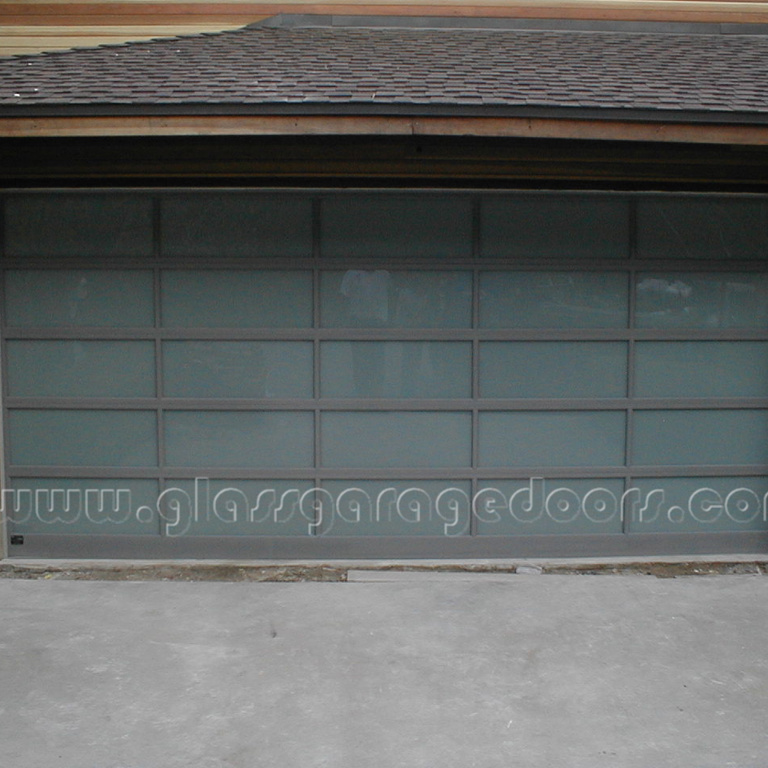 Gray Powder coated residential Glass garage door in wood wall