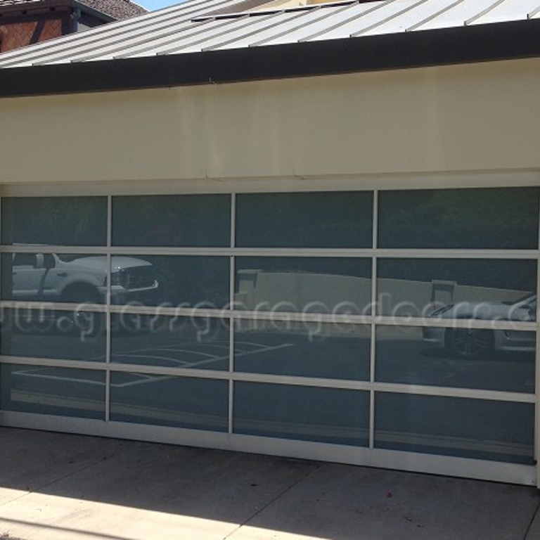 Custom-designed glass garage door in a modern Malibu property