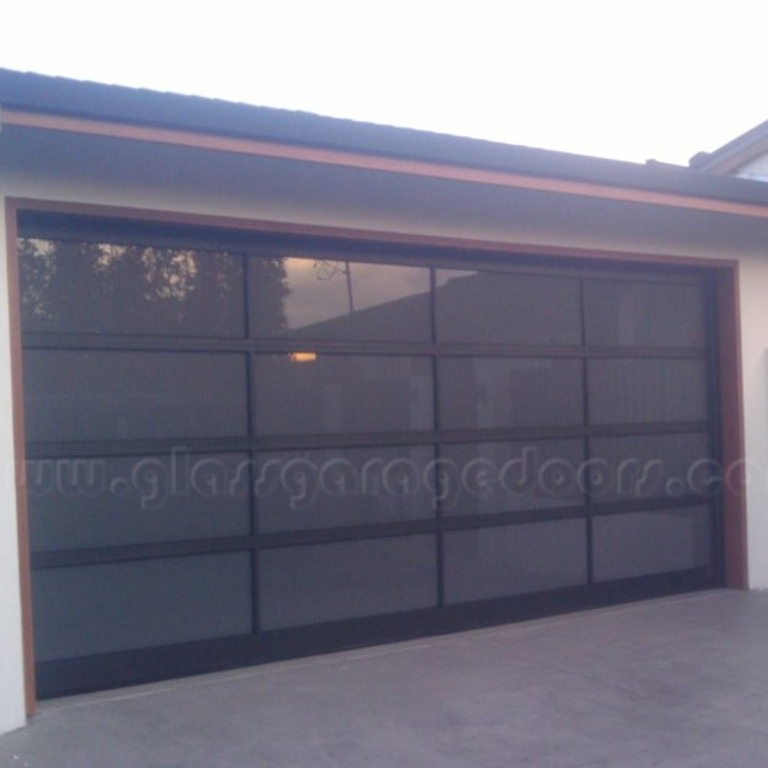 black glass garage door in Beverly Hills, California, adding a sophisticated look to luxury home