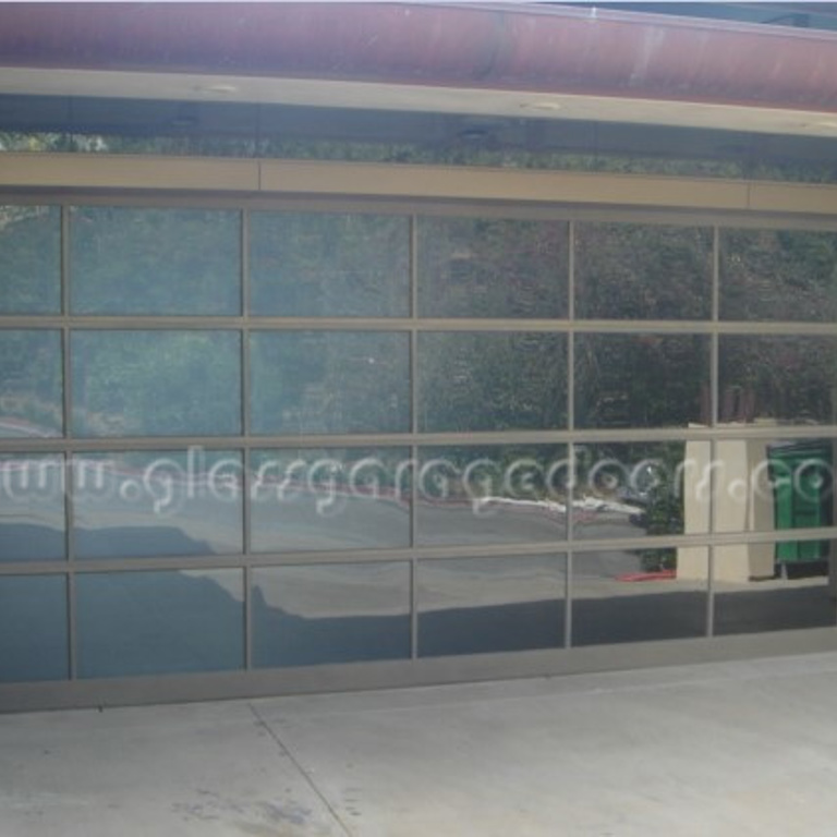 Modern Bronze glass garage door with gray glass installed in Laguna Beach California