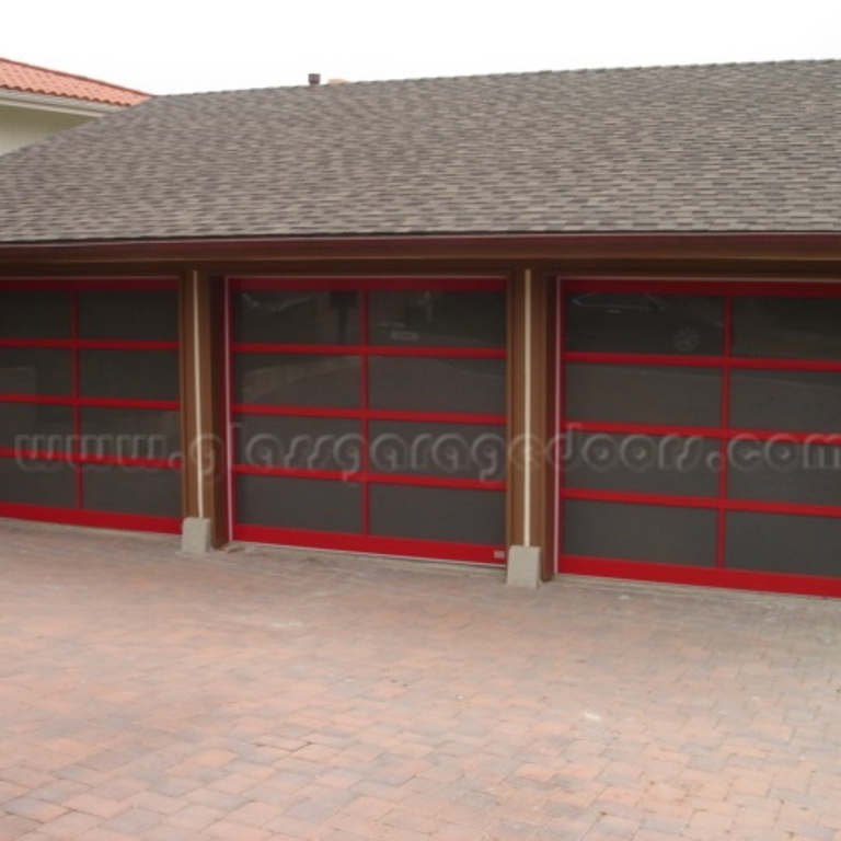 set of three vibrant red glass garage doors enhancing contemporary architecture in Palos Verdes Calinfornia