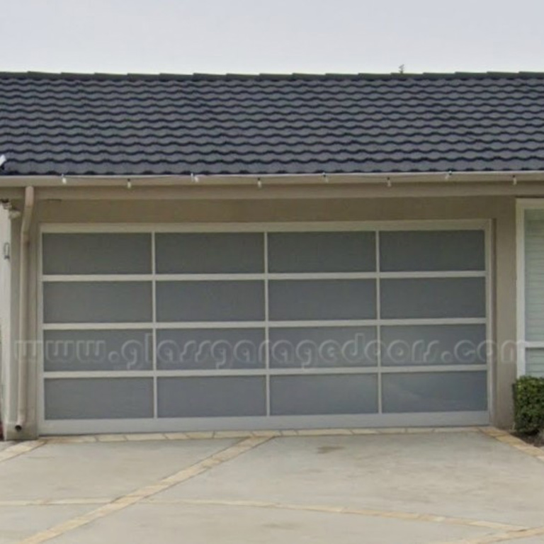 Modern glass garage door complementing a Palos Verdes California home's exterior