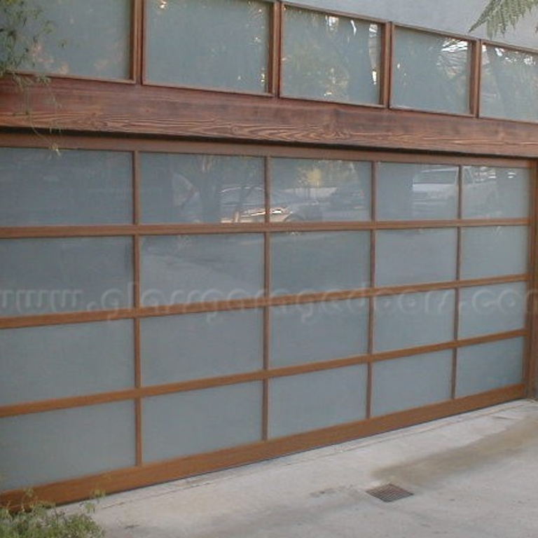 Contemporary garage door with wood-like finish and glass panels in Pacific Palisades California