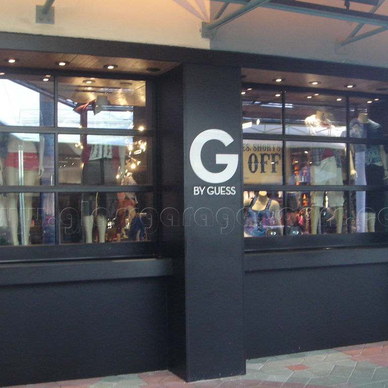 Black Glass Garage Door in Guess clothing store in Fort lauderdale shopping center