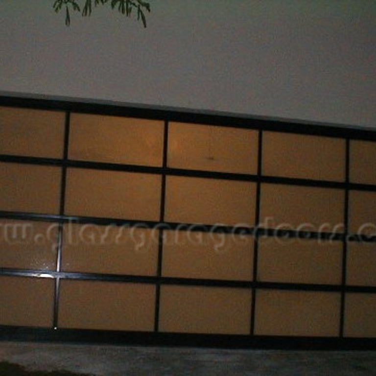 Black contemporary glass garage door with sleek design in Beverly Hills, CA