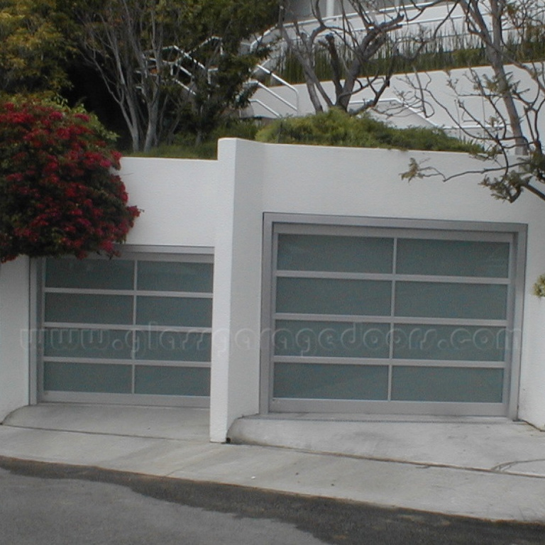 Contemporary Pacific Palisades home featuring two custom glass garage doors