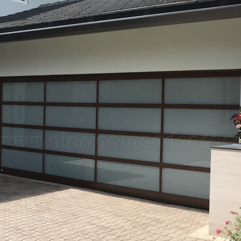 Premium hurricane-rated glass garage door enhancing security and style in a Fort Lauderdale luxury residence