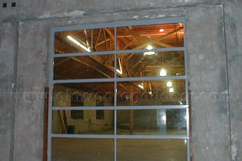 glass overhead door in a warehouse unloading zone, designed for seamless entry and exit while maintaining security and visibility