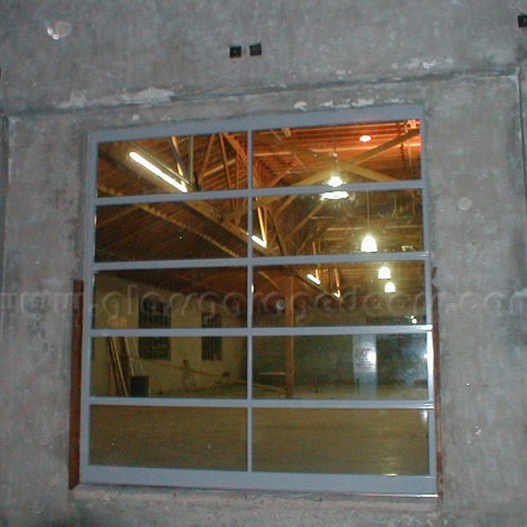 glass overhead door in a warehouse unloading zone, designed for seamless entry and exit while maintaining security and visibility