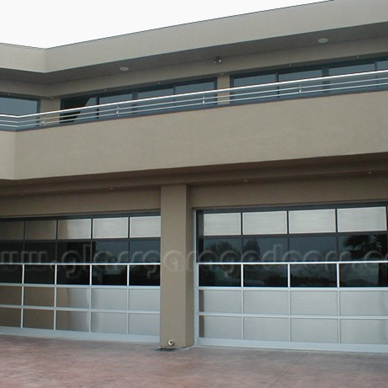 Modern building in Dana Point, California with two sleek glass garage doors, combining style and functionality.