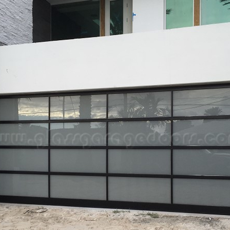 Black glass garage door installed in luxury residence in fort lauderdale, florida