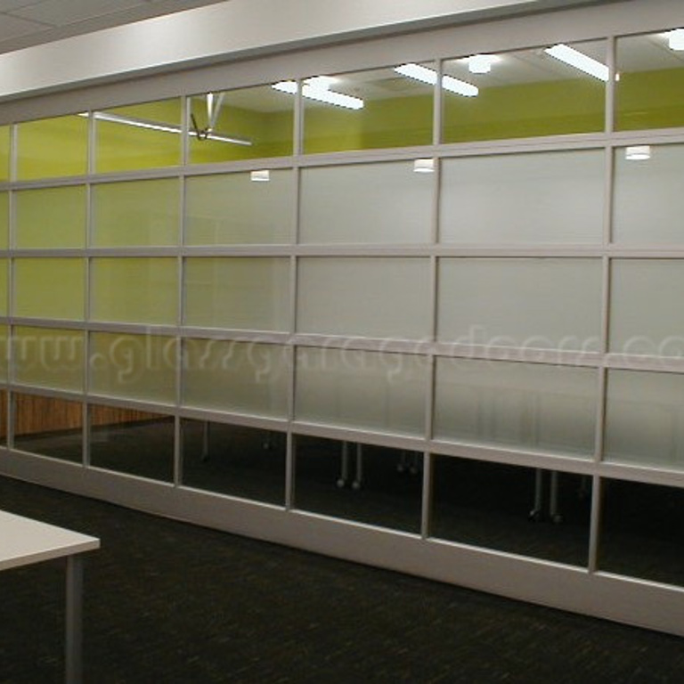 Glass garage door as a room divider in a conference room within an Irvine, California building, creating a seamless, modern workspace