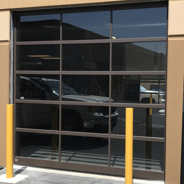 brown glass garage door installed in commercial building in San Diego