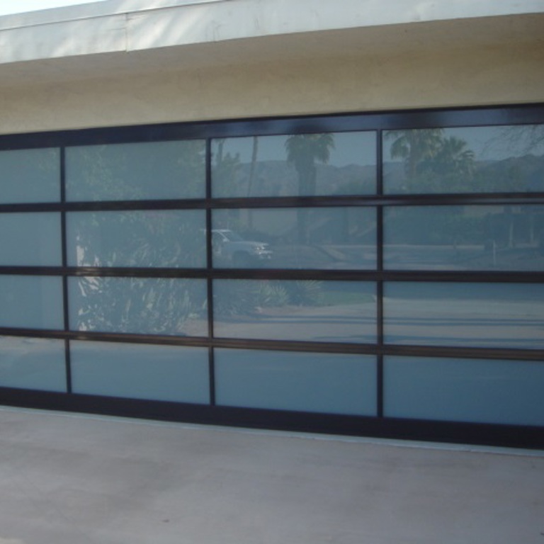 Modern dark glass garage door with a stylish design in Rancho Mirage California