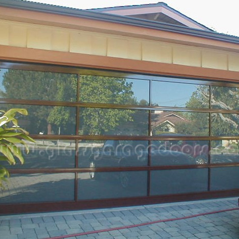 wood powder coated paint aluminum glass garage door installed on a residence in Newport Beach california