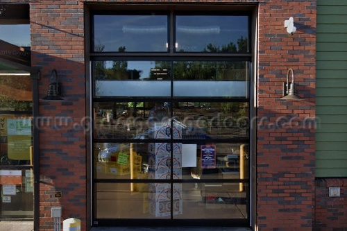 Energy-efficient insulated overhead glass door in a grocery store, providing temperature control while maintaining visibility and easy access