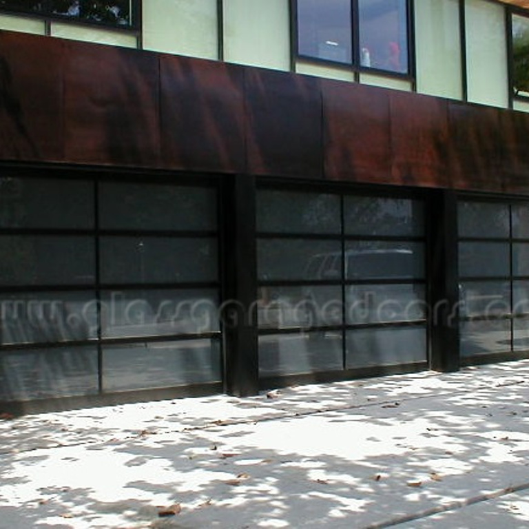 Elegant trio of glass garage doors on a Pasadena residential property, blending modern architecture with stylish transparency