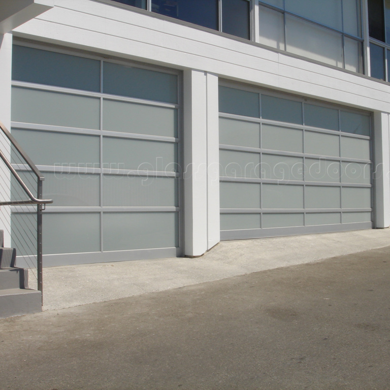 Three modern glass overhead doors enhancing the architectural design of a Malibu building