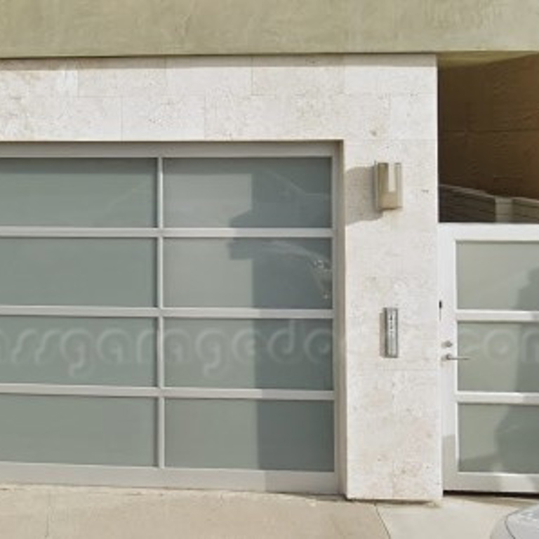 Stylish glass garage door and entry door design at a Newport Beach residential property