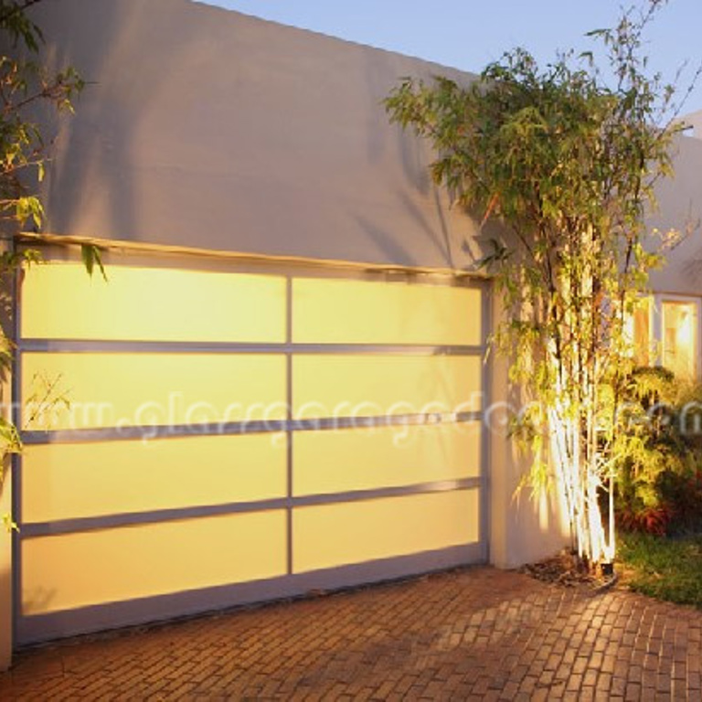 Glass Overhead sectional door installed in residence driveway in Fort Lauderdale, Florida