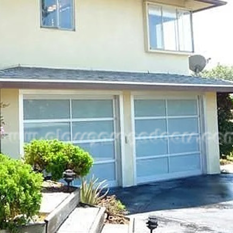 Stylish pair of glass garage doors on a residential property in Pasadena, CA, providing a luxurious and open look to the home's exterior