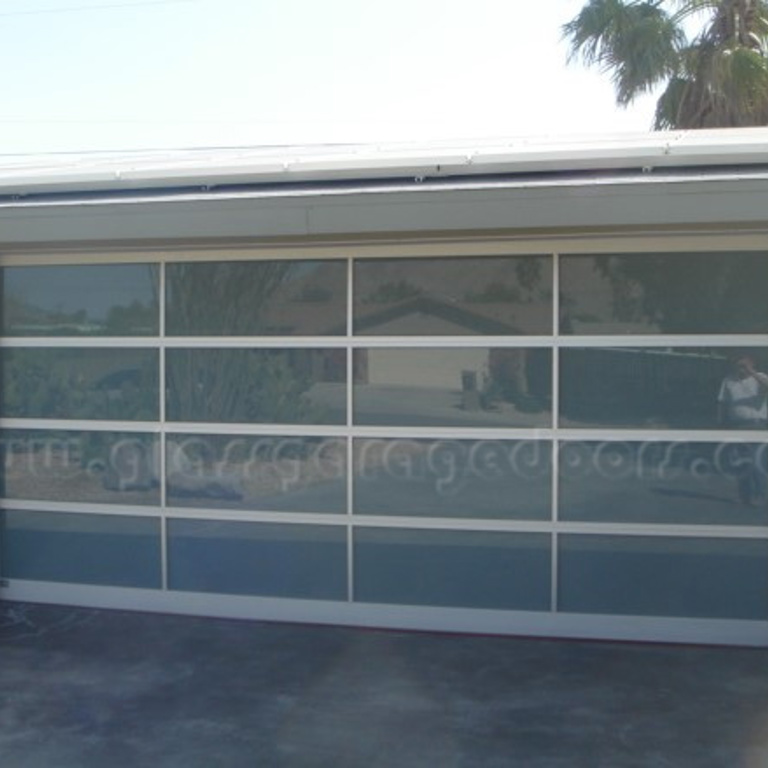 Glass Garage Door installed in residential driveway in Palm Springs, California