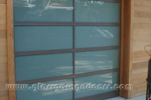 Brown frame and obscured Glass Garage Door in wood wall