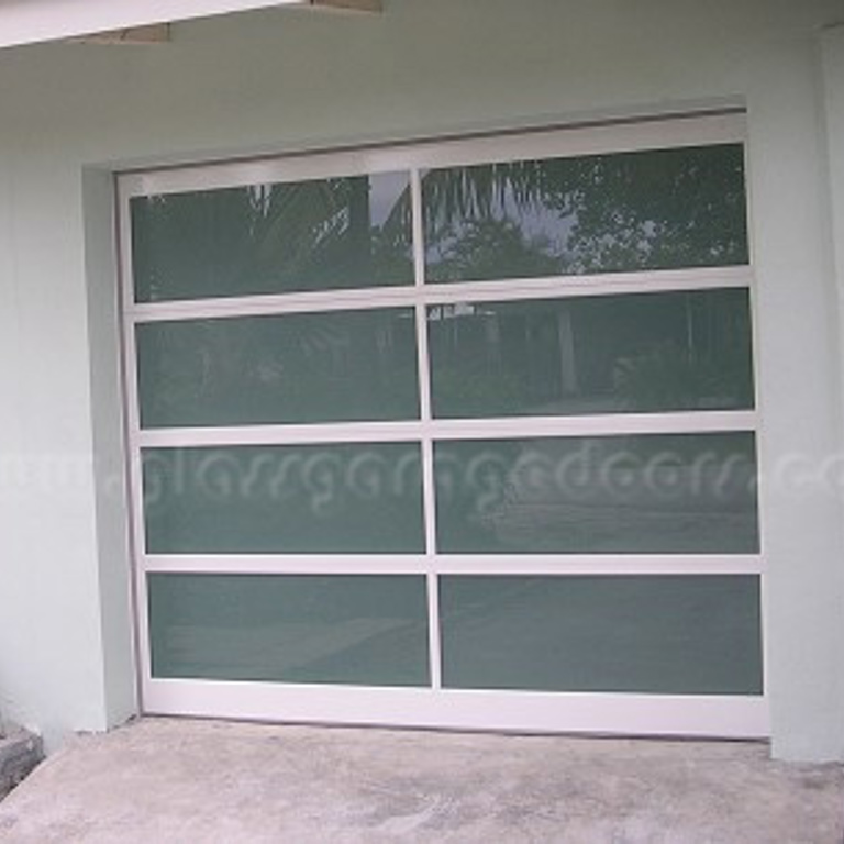 hurricane rated Overhead sectional glass door with insulated frame installed in home in Fort Lauderdale , florida