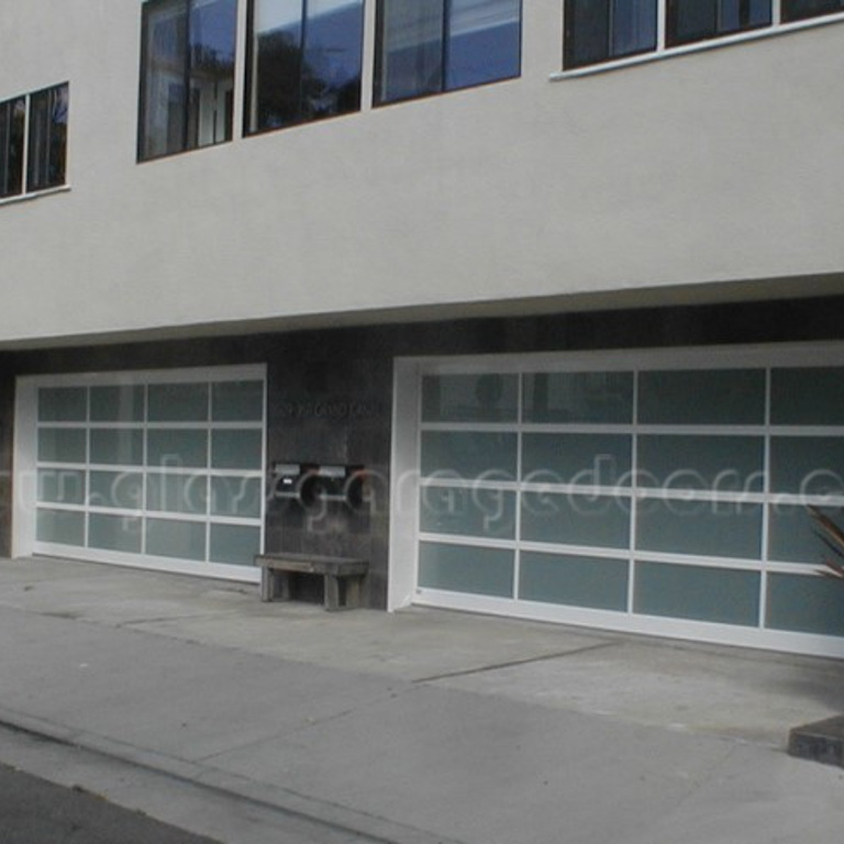 Dual glass garage doors providing secure and attractive parking access at apartment complex on grand canal in Marina del Rey California