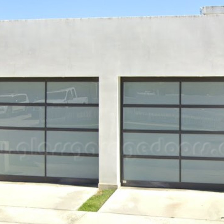 Two modern glass garage doors at a residence on Galaxy Drive in  Newport Beach california