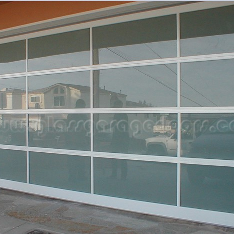 Redondo Beach, California, home featuring a stylish glass garage door that adds to its modern aesthetic.