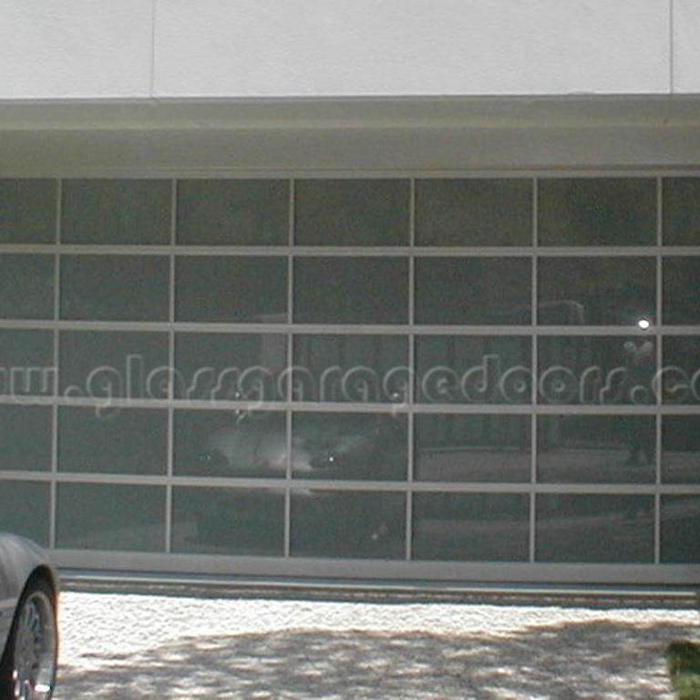 Modern residential glass garage door on Stone Canyon Road, Los Angeles, enhancing driveway appeal with its sleek design and natural light