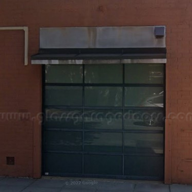 Modern glass garage door installation in a commercial building in Pasadena, CA, offering sleek design and enhanced curb appeal