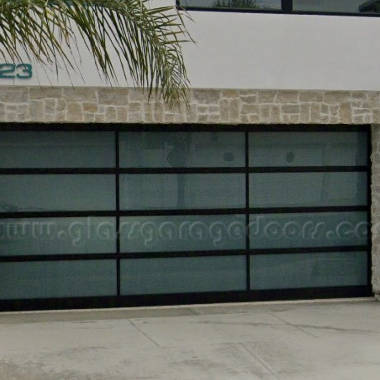 Contemporary black glass garage door for beach residence in Newport Beach California