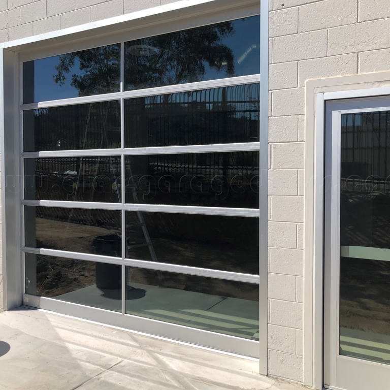 Aluminum and Glass Garage door with side Entry Door intalled on building in Alvarado Canyon, in San Diego California